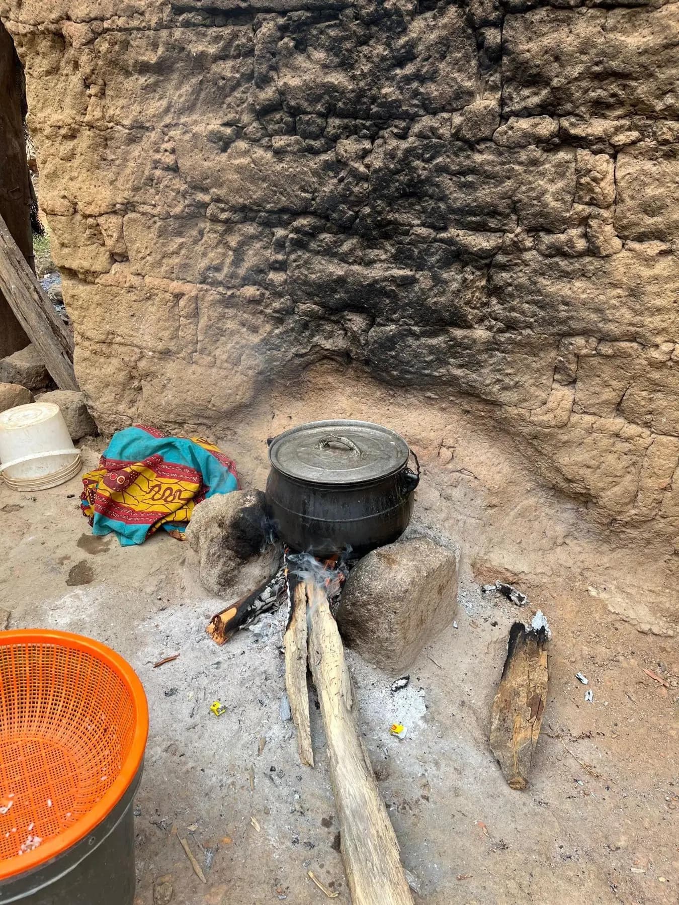 A traditional three-stone cooking fire in Piko Village