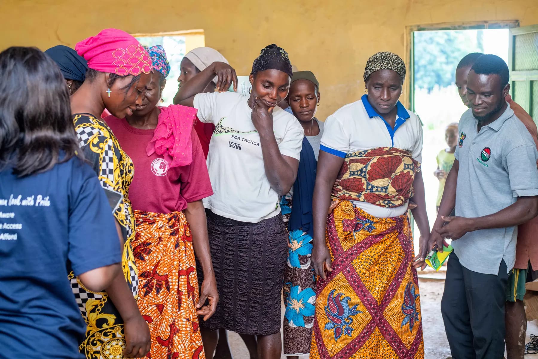 Community members observing a practical clean cooking demonstration