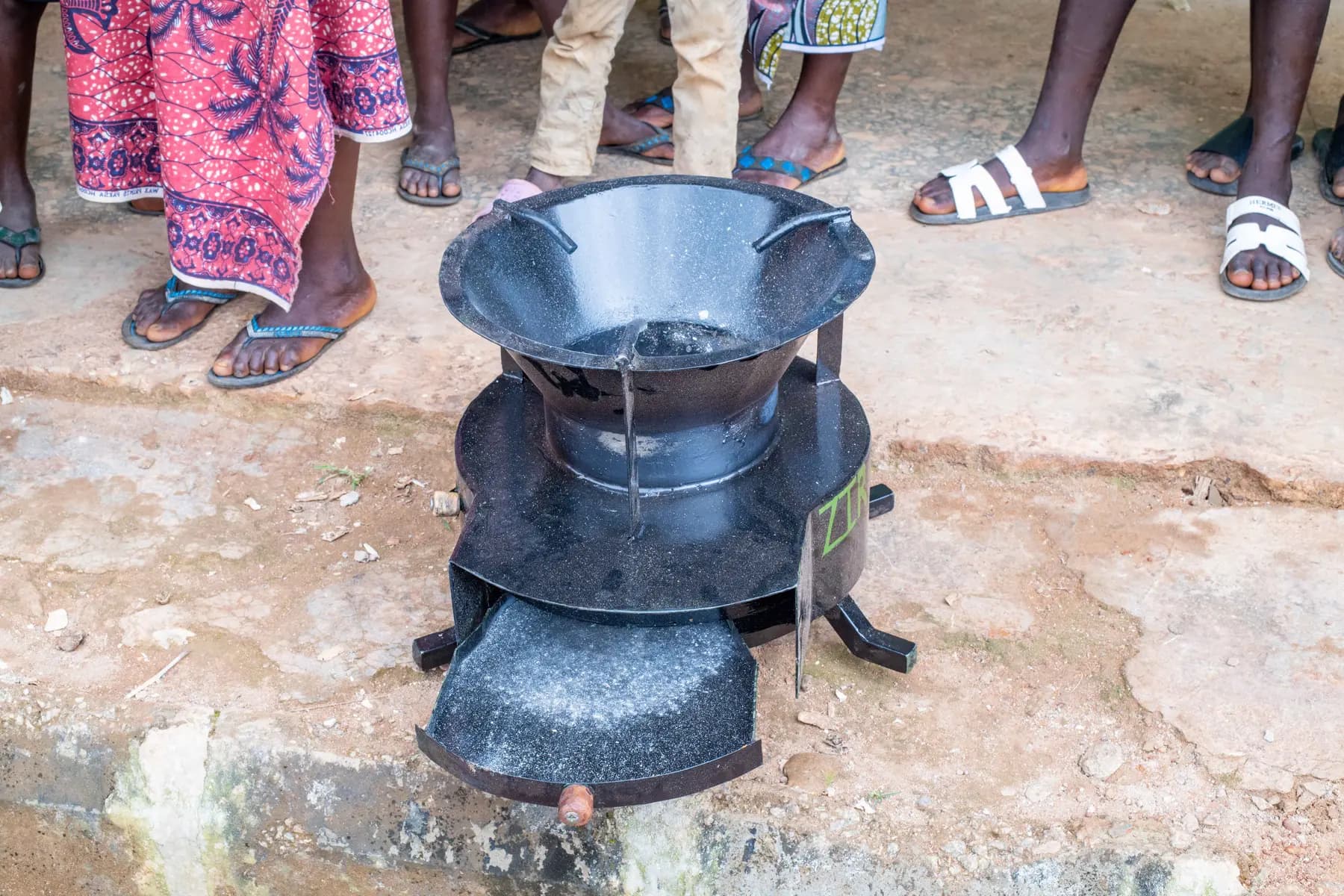 Community participants examining the ZiRA clean cookstove